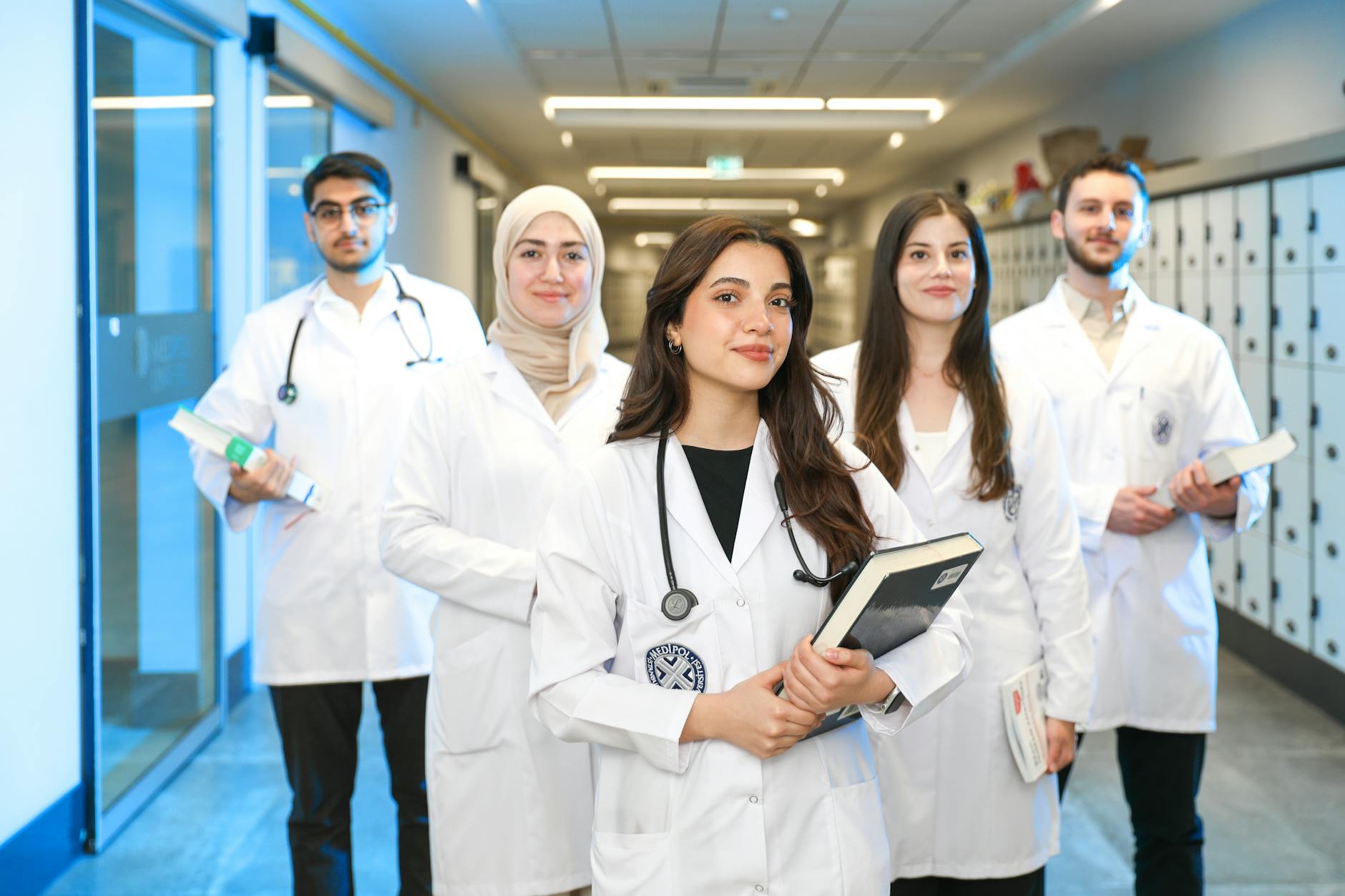 Medical students reviewing case notes together in a hospital setting